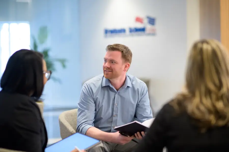 A Graduate School USA advisor working with two federal employees