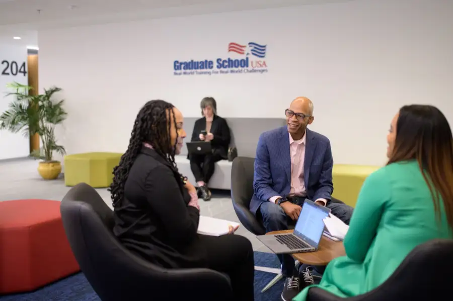 Three federal leaders in discussion at Graduate School USA